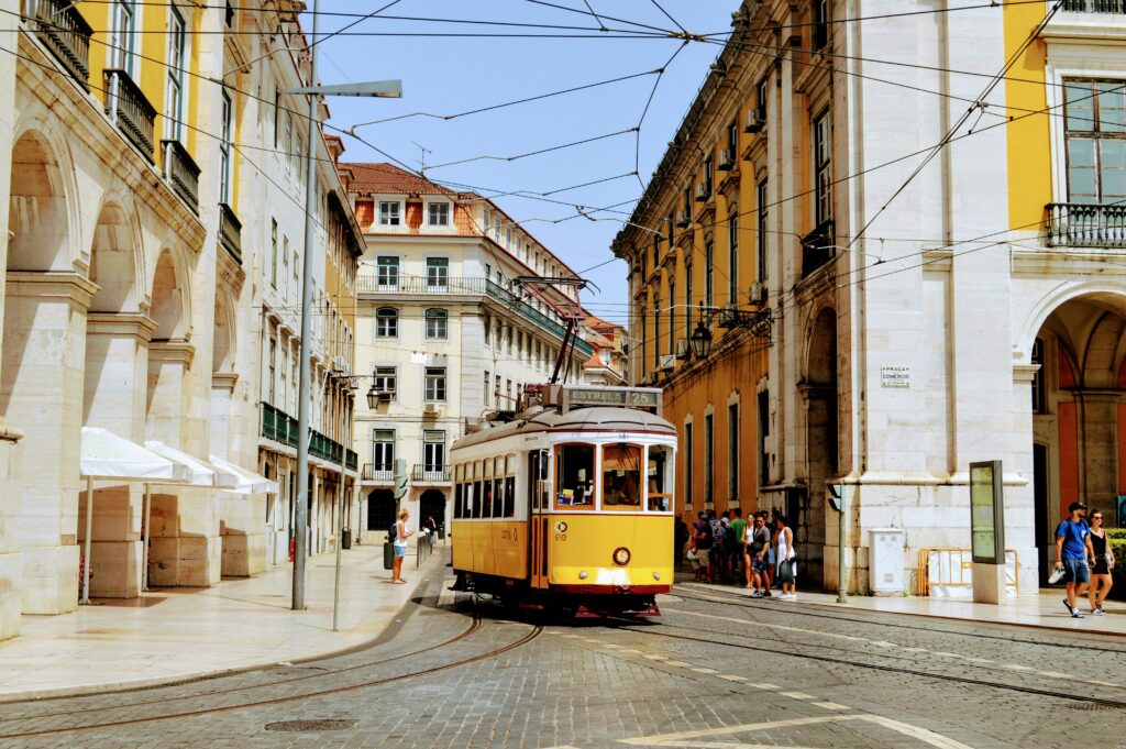 A yellow tram in Lisbon winding through historic streets, perfect for value urban travel 2025