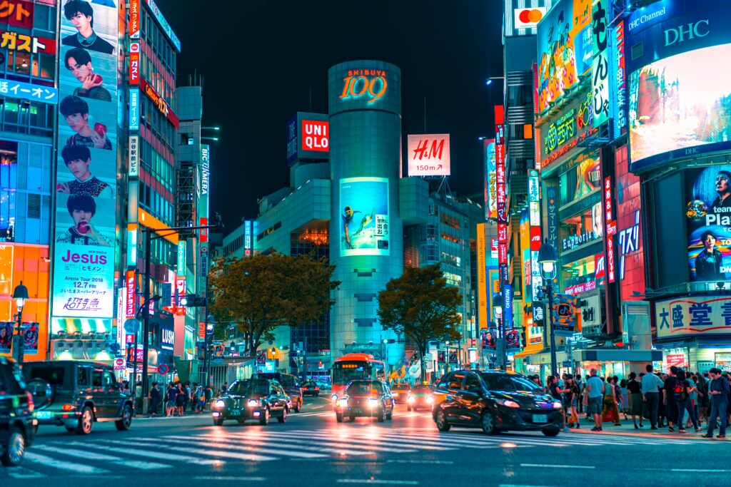 A bustling Shibuya Crossing in Tokyo at night with neon lights, a top value urban travel 2025 spot