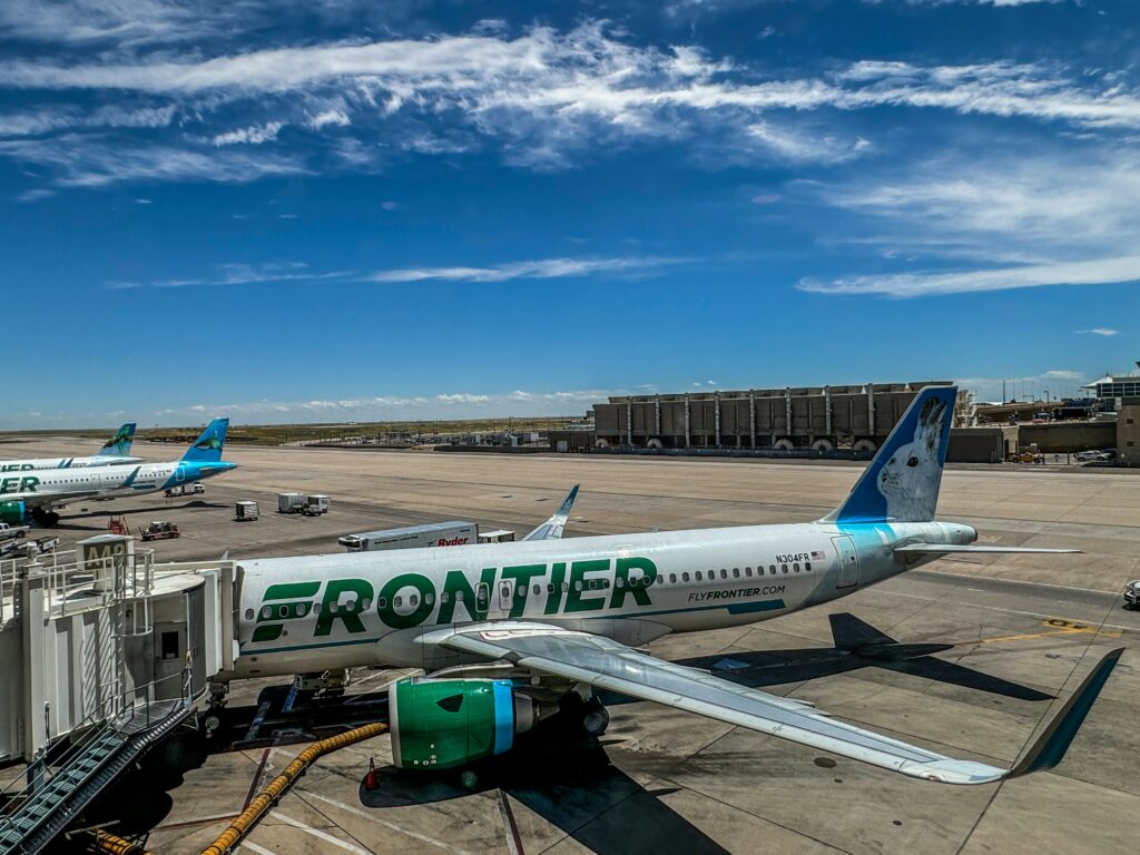 Airplane at gate with Frontier vibe