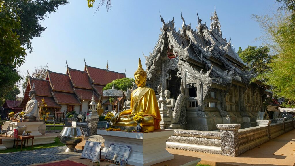 A peaceful Buddhist temple in Chiang Mai with golden statues and a meditative atmosphere, a top value wellness travel 2025 spot