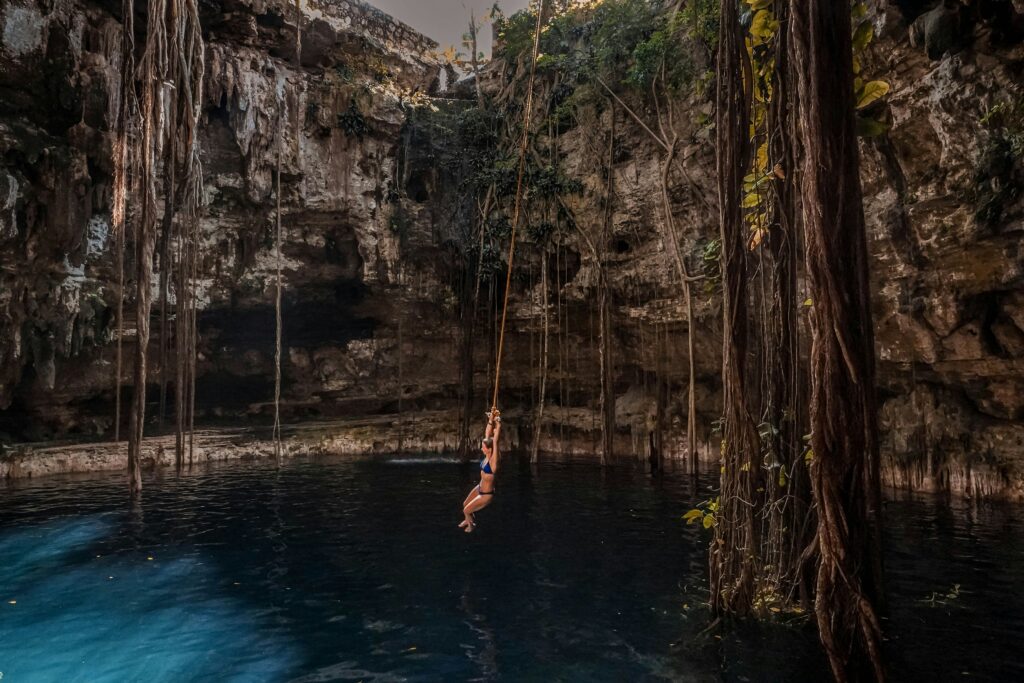 A clear blue cenote in Tulum, Mexico, surrounded by lush greenery, perfect for a value wellness travel 2025 dip.