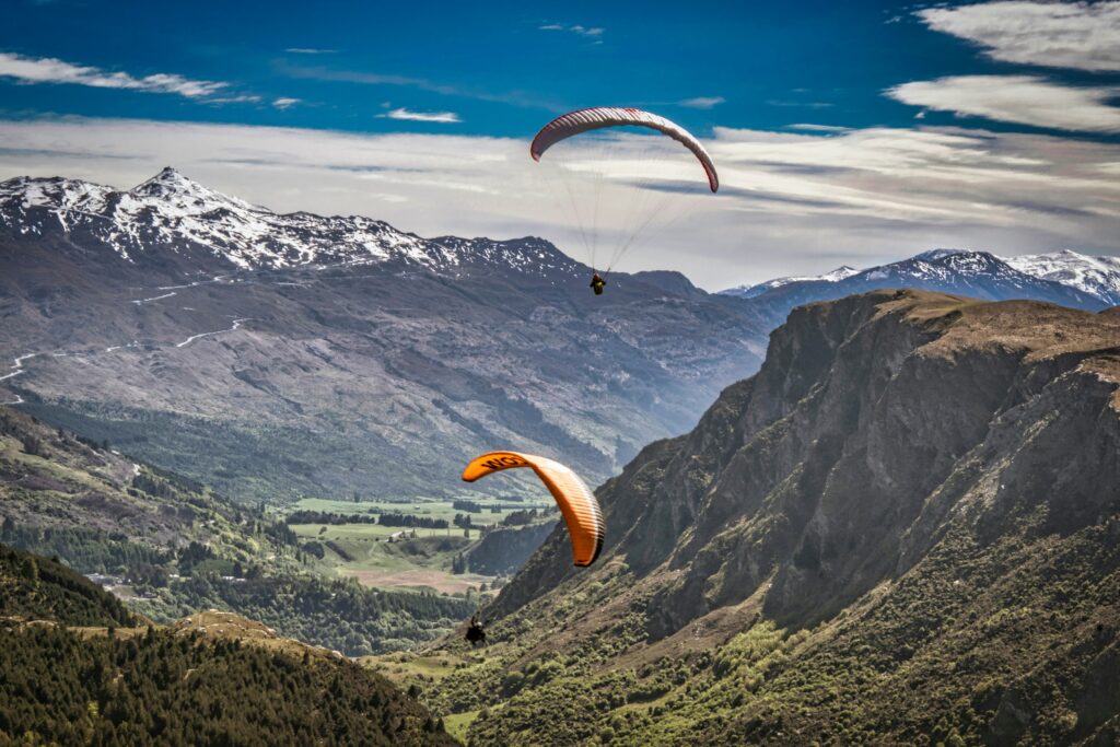  A bungee jumper at Kawarau Bridge in Queenstown with mountains, ideal for value adventure travel 2025.