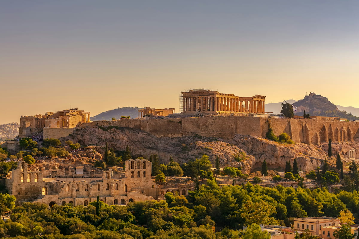 The Acropolis and Parthenon bathed in golden hour light, overlooking the Athens cityscape