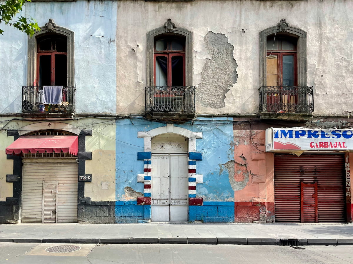 Mexico City skyline at dusk with Paseo de la Reforma and the Angel of Independence glowing in golden light
