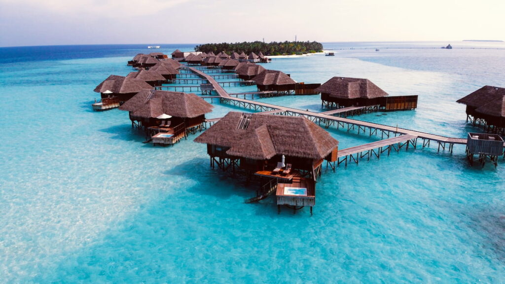 Maldives overwater bungalows above crystal-clear turquoise lagoon