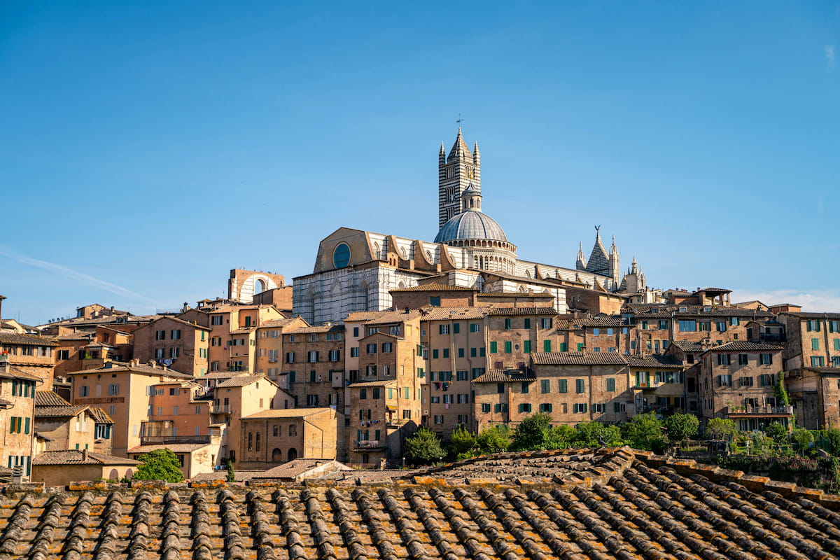 Medieval Tuscan hill town with stone towers rising above terracotta rooftops