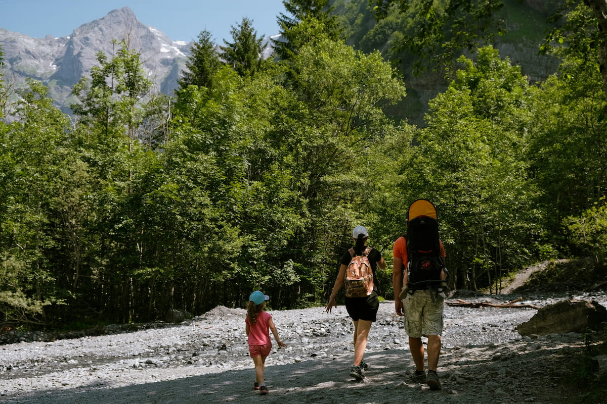 Family exploring a national park trail with mountain scenery