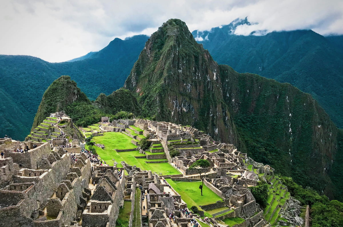 Aerial view of Machu Picchu citadel with Huayna Picchu mountain rising behind the ancient Inca terraces