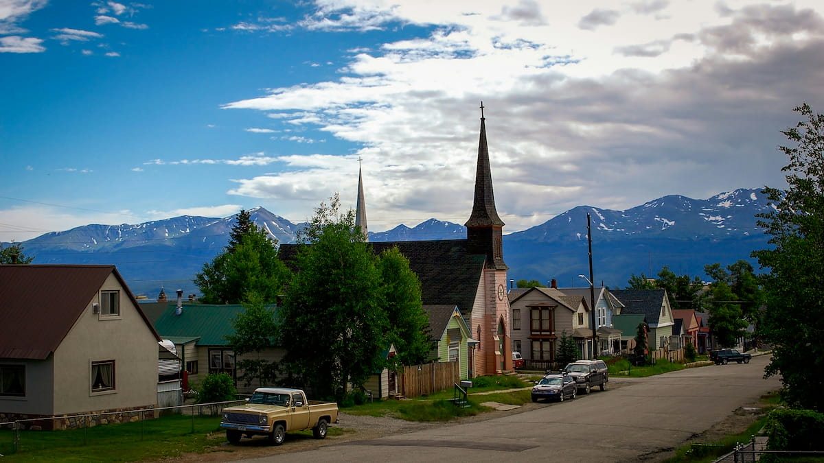 Denver skyline with the Rocky Mountains visible in the background on a clear day
