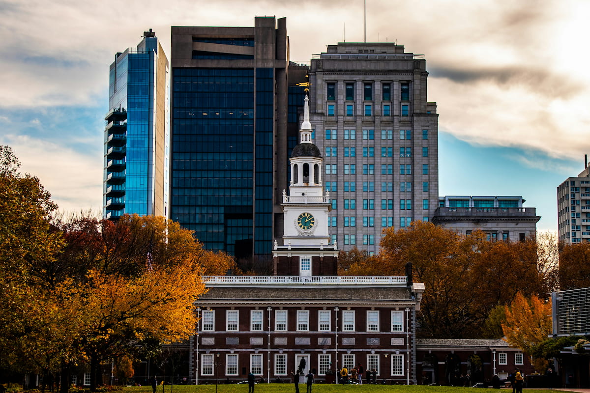 Philadelphia skyline with historic buildings and the Liberty Bell area at dusk