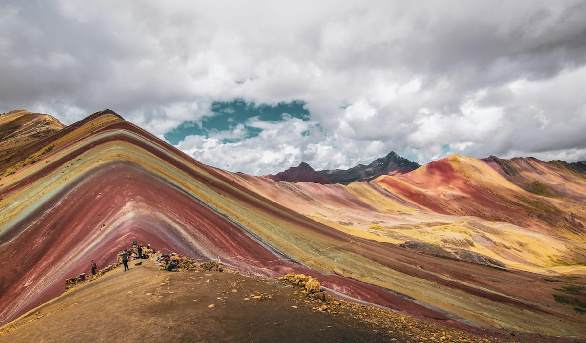 Vibrant Cusco market stalls with colorful textiles and produce in the Sacred Valley of Peru