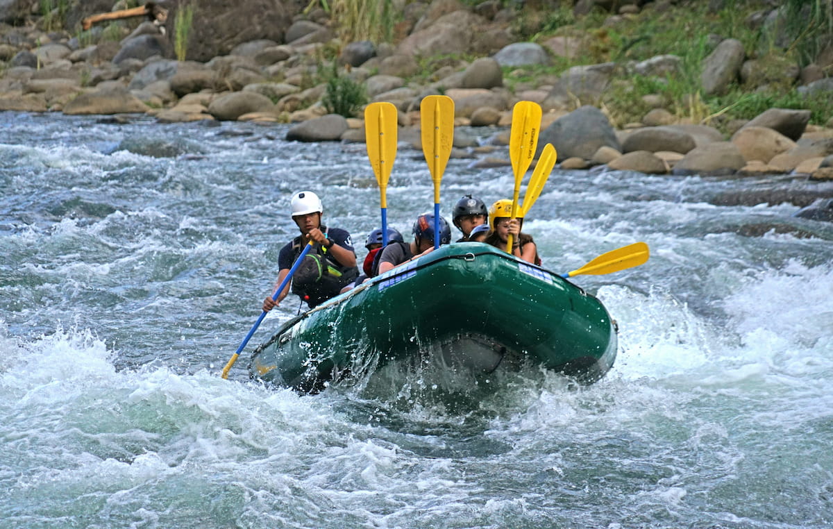White water rafters navigating rapids on the Río Pacuare in Costa Rica jungle gorge