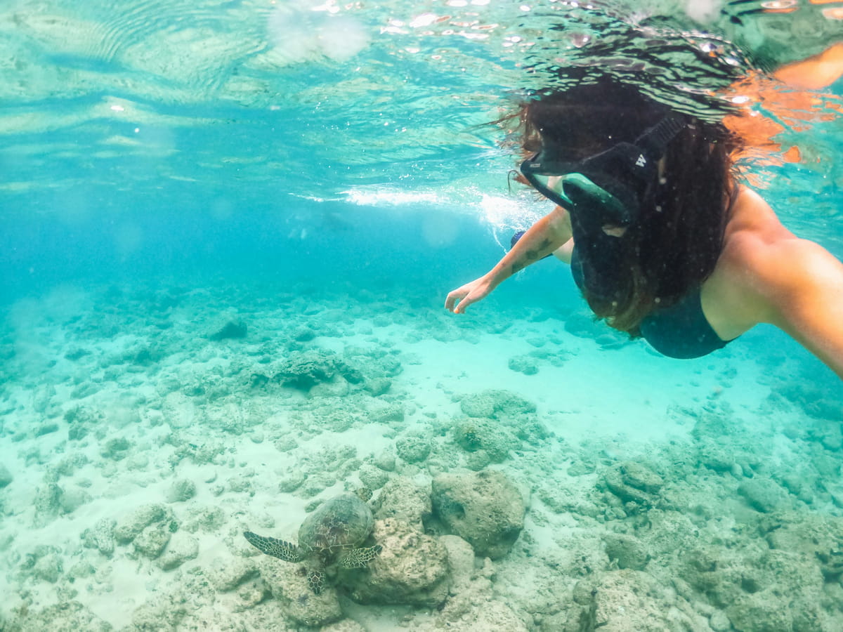 Snorkeler underwater exploring the coral reef at Hanauma Bay Nature Preserve, Oahu