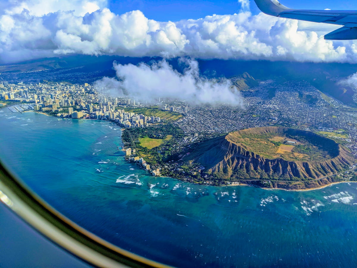 Oahu Diamond Head crater and Waikiki Beach with calm blue Pacific water and city skyline