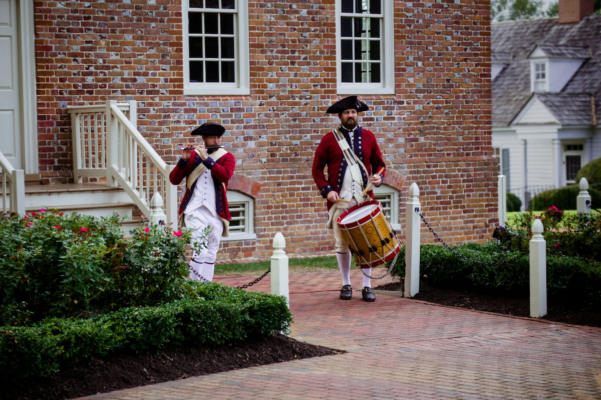 Colonial Williamsburg historic district with 18th-century buildings and costumed interpreters on Duke of Gloucester Street